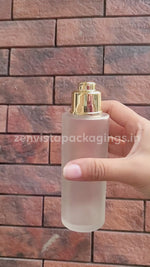 Load and play video in Gallery viewer, |ZMG43|  FLAT SOLDER FROSTED GLASS BOTTLE WITH GOLD PLATED LOCKET CAP Available Size: 25ml, 30ml, 50ml, 100ml
