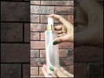 Load and play video in Gallery viewer, ( ZMT119 ) FLAT SHOULDER FROSTED CLEAR PET ROUND BOTTLE WITH GOLD PLATED WHITE MIST SPRAY PUMP Available Size: 100ml &amp; 200ml
