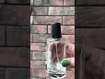 Load and play video in Gallery viewer, [ZMS17] Transparent Round Glass Perfume Bottle With Simple Black Cap - 50ml
