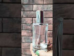 Load and play video in Gallery viewer, [ZMS15] Transparent Round Glass Perfume Bottle With Silver Cap - 50ml
