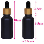 Load image into Gallery viewer, black glass , glass black color bottles , 30ml black droppers , gold plated black droppers , droppers for essential oils , glass droppers , black frosted glass, gold plated black droppers , 30 ml droppers .
